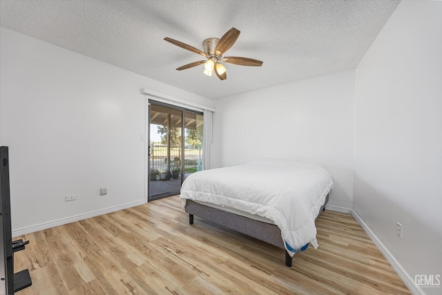 5600 Kirkside Dr Unit F, Bakersfield, CA 93311 - bedroom featuring access to exterior, wood finished floors, a textured ceiling, baseboards, and a ceiling fan