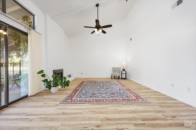 5600 Kirkside Dr Unit F, Bakersfield, CA 93311 - spare room with wood finished floors, ceiling fan, a fireplace, high vaulted ceiling, and baseboards