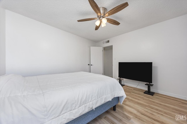 5600 Kirkside Dr Unit F, Bakersfield, CA 93311 - bedroom with wood finished floors, a textured ceiling, a ceiling fan, and baseboards