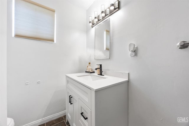 bathroom with toilet, tile patterned floors, and vanity