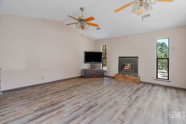 22381 William Tell Trl, Tehachapi, CA 93561 - unfurnished living room with a ceiling fan, lofted ceiling, wood finished floors, and a glass covered fireplace