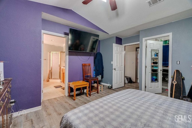 22381 William Tell Trl, Tehachapi, CA 93561 - bedroom with lofted ceiling, wood finished floors, ensuite bathroom, a ceiling fan, and a textured wall