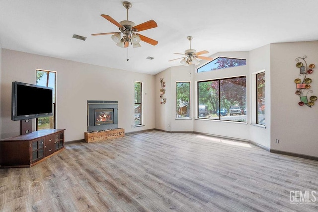 22381 William Tell Trl, Tehachapi, CA 93561 - unfurnished living room featuring wood finished floors, lofted ceiling, ceiling fan, and a glass covered fireplace
