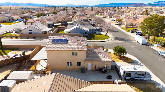 birds eye view of property with a mountain view and a residential view