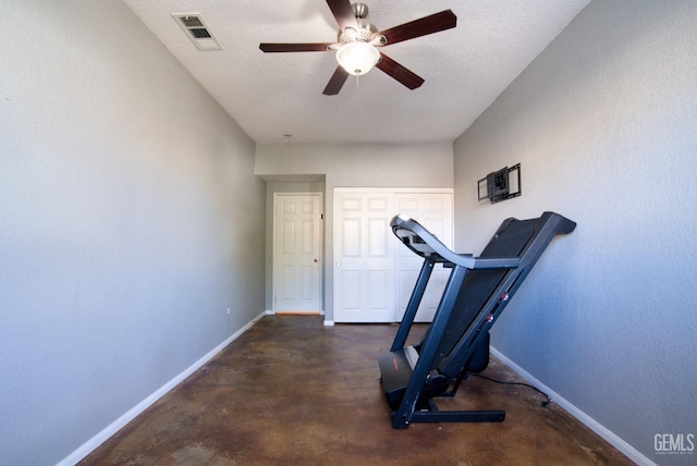 workout area with a textured ceiling, a ceiling fan, visible vents, and baseboards