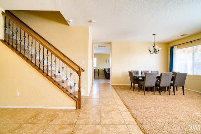 dining area with a notable chandelier, light tile patterned floors, visible vents, a textured ceiling, and stairs