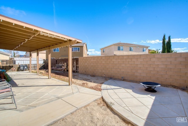 view of patio featuring a fire pit and a fenced backyard