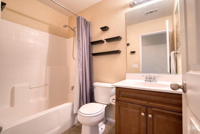 bathroom featuring a textured ceiling, a textured wall, toilet, visible vents, and tile patterned floors