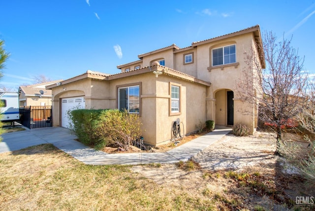 mediterranean / spanish home featuring a garage, driveway, fence, and stucco siding