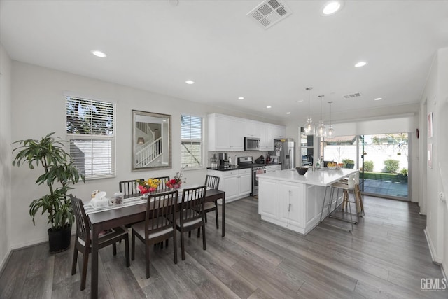 kitchen with white cabinetry, a healthy amount of sunlight, visible vents, and appliances with stainless steel finishes