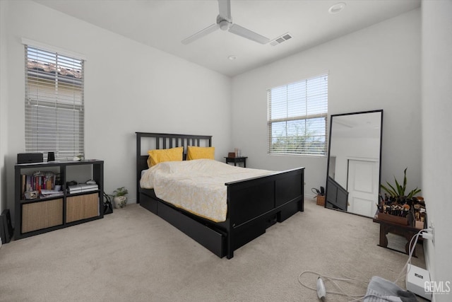 carpeted bedroom featuring visible vents and ceiling fan