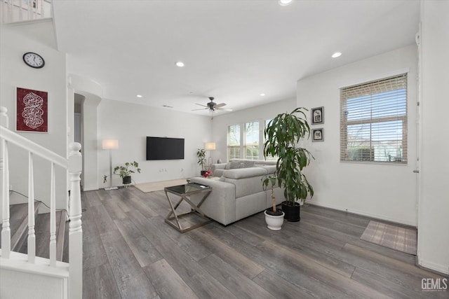 living area with wood finished floors, recessed lighting, stairway, arched walkways, and ceiling fan