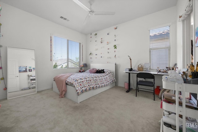 carpeted bedroom featuring visible vents and ceiling fan