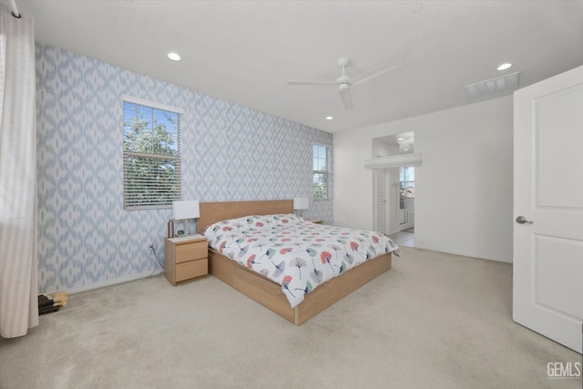 carpeted bedroom with visible vents, multiple windows, recessed lighting, wallpapered walls, and baseboards