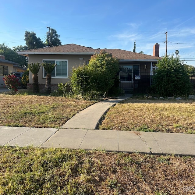 2625 E Michigan Ave, Fresno, CA 93703 - bungalow with stucco siding and a chimney