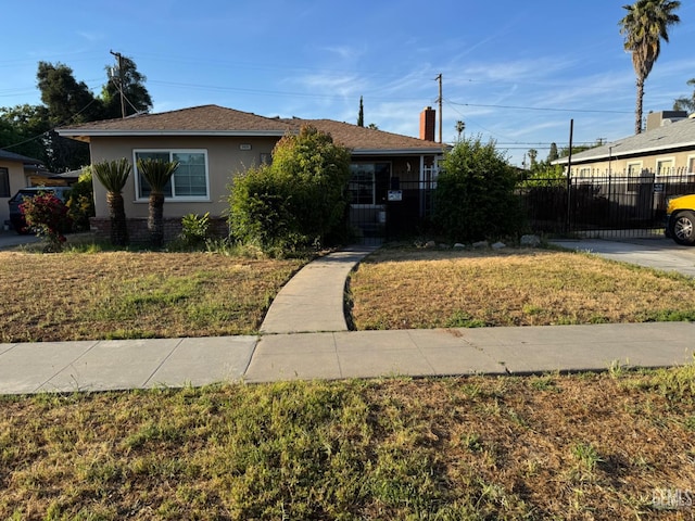 2625 E Michigan Ave, Fresno, CA 93703 - bungalow-style home featuring stucco siding and a chimney