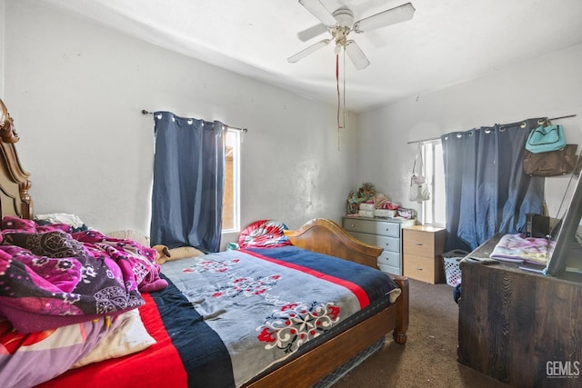 bedroom featuring ceiling fan and dark carpet