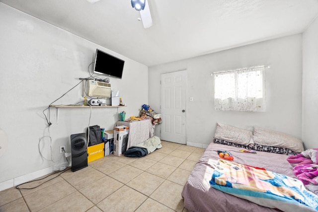 tiled bedroom featuring ceiling fan