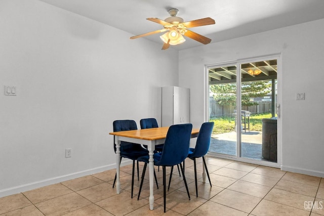 dining area with light tile patterned floors, baseboards, and ceiling fan
