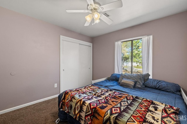 bedroom featuring baseboards, carpet, visible vents, and a closet