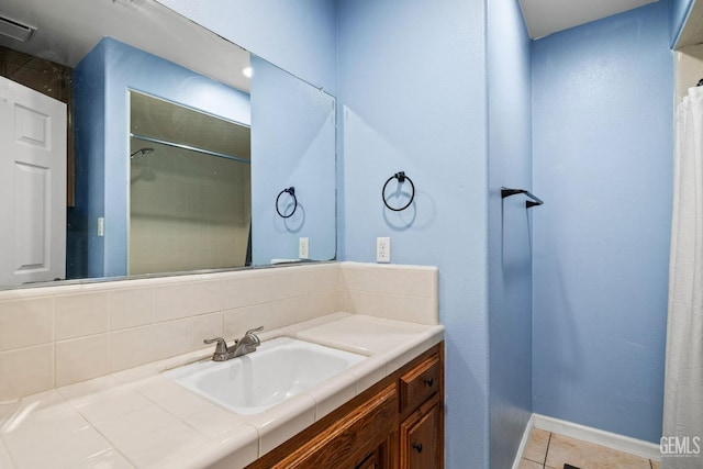 bathroom with visible vents, baseboards, tile patterned floors, and vanity