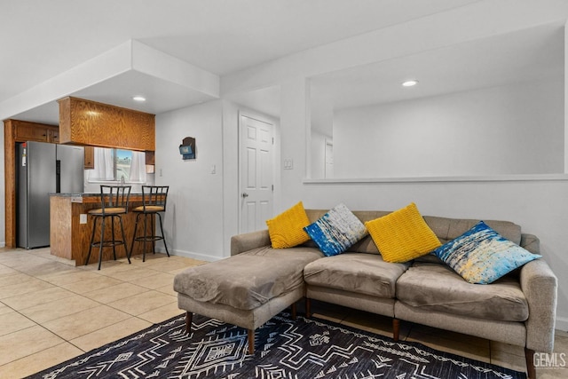 living area with baseboards, recessed lighting, and light tile patterned flooring