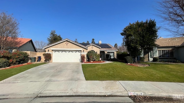 ranch-style home featuring a garage, a front lawn, and solar panels