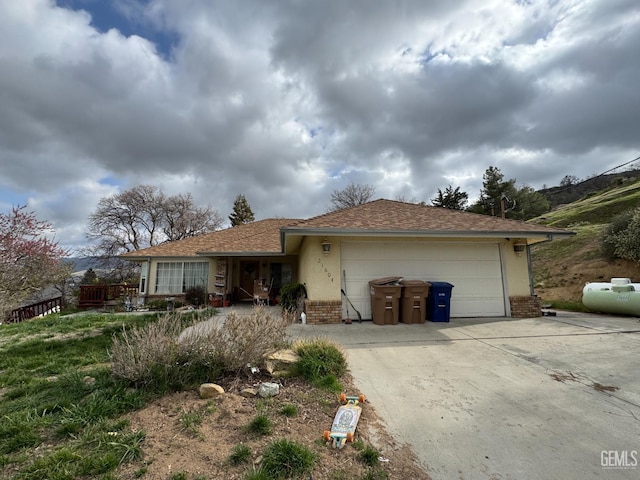 21604 Diane Ct, Tehachapi, CA 93561 - ranch-style house with brick siding, driveway, an attached garage, and a shingled roof