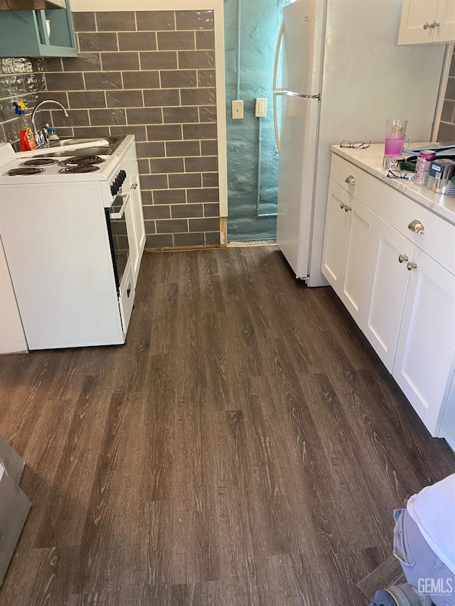 2104 B St, Bakersfield, CA 93301 - kitchen featuring white appliances, dark wood finished floors, white cabinetry, light countertops, and tile walls