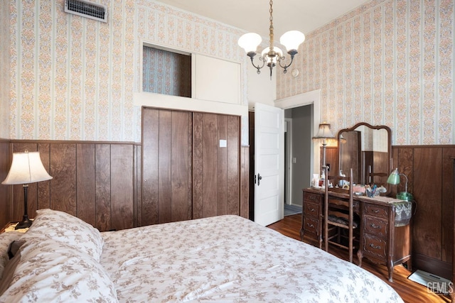 2104 B St, Bakersfield, CA 93301 - bedroom featuring wainscoting, wallpapered walls, a chandelier, wood finished floors, and wooden walls