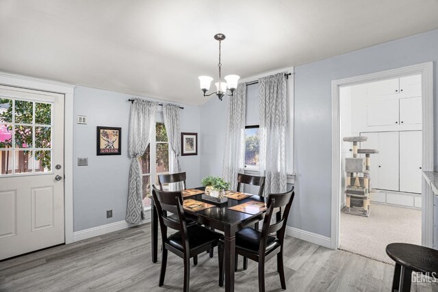 2104 B St, Bakersfield, CA 93301 - dining space featuring light wood finished floors, a chandelier, healthy amount of natural light, and baseboards