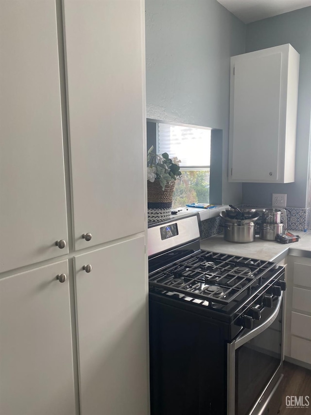 2104 B St, Bakersfield, CA 93301 - kitchen featuring gas stove, light countertops, and white cabinets