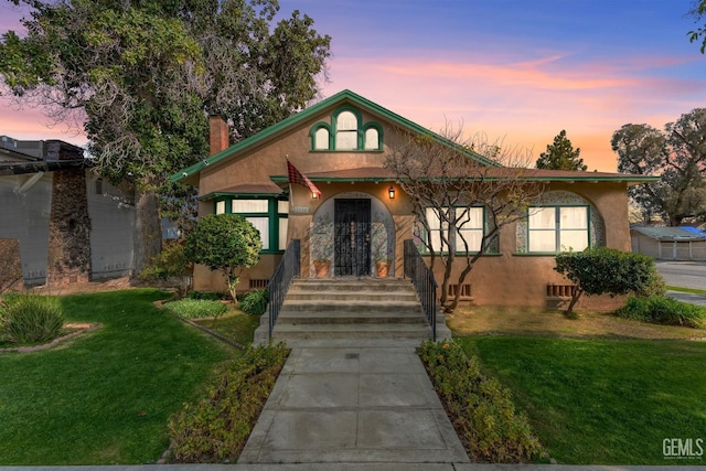 2104 B St, Bakersfield, CA 93301 - view of front of property featuring stucco siding, a chimney, a yard, and concrete driveway