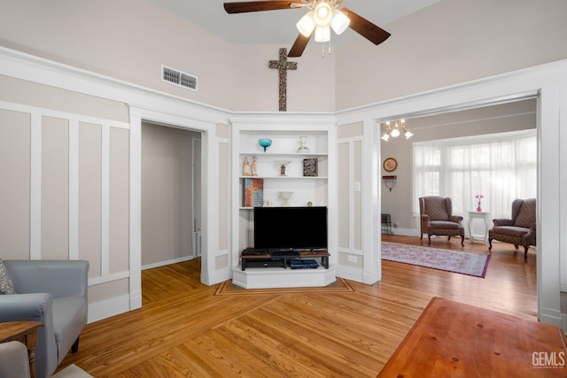 2104 B St, Bakersfield, CA 93301 - living area featuring a towering ceiling, light wood-type flooring, a ceiling fan, and built in features