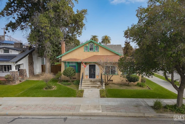 2104 B St, Bakersfield, CA 93301 - view of front of house with stucco siding, a front lawn, and a chimney