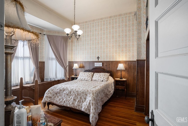 2104 B St, Bakersfield, CA 93301 - bedroom featuring wainscoting, wallpapered walls, wood finished floors, a chandelier, and wood walls