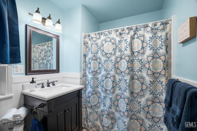 2104 B St, Bakersfield, CA 93301 - full bathroom featuring wainscoting, vanity, and a shower with curtain