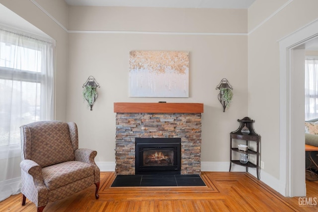 2104 B St, Bakersfield, CA 93301 - living area featuring plenty of natural light, a stone fireplace, baseboards, and wood finished floors