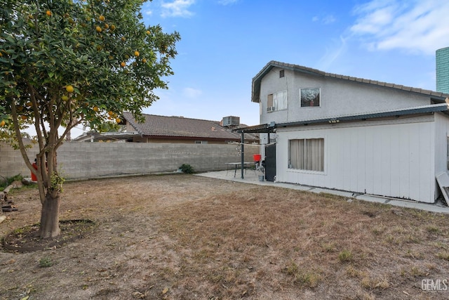 rear view of house with cooling unit and a patio