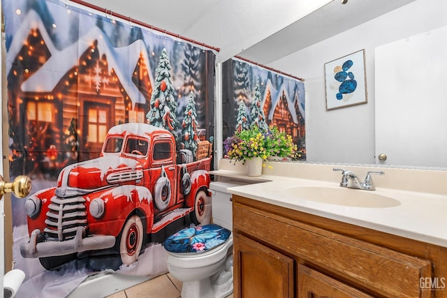 bathroom with tile patterned floors, vanity, toilet, and walk in shower