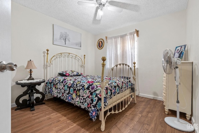 bedroom featuring ceiling fan, wood-type flooring, and a textured ceiling