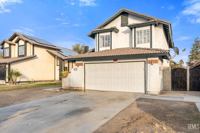 view of front of property with solar panels and a garage