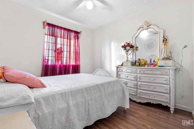 bedroom featuring ceiling fan, wood-type flooring, and a textured ceiling