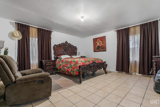 tiled bedroom featuring a textured ceiling