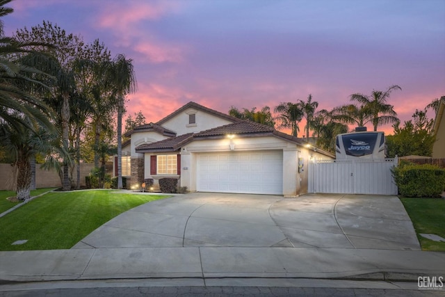 view of front facade with a yard and a garage