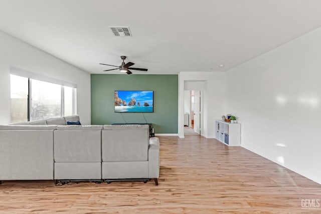 living room with ceiling fan and light hardwood / wood-style floors