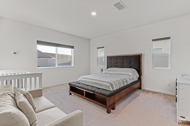 bedroom featuring light carpet