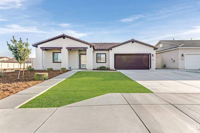 mediterranean / spanish-style house with a tile roof, stucco siding, an attached garage, driveway, and a front lawn