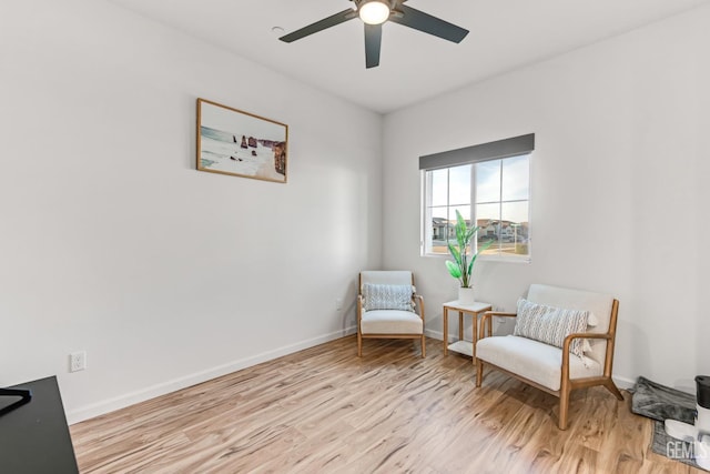 sitting room with ceiling fan and light hardwood / wood-style floors