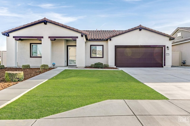 mediterranean / spanish-style house with concrete driveway, stucco siding, a tile roof, an attached garage, and a front yard